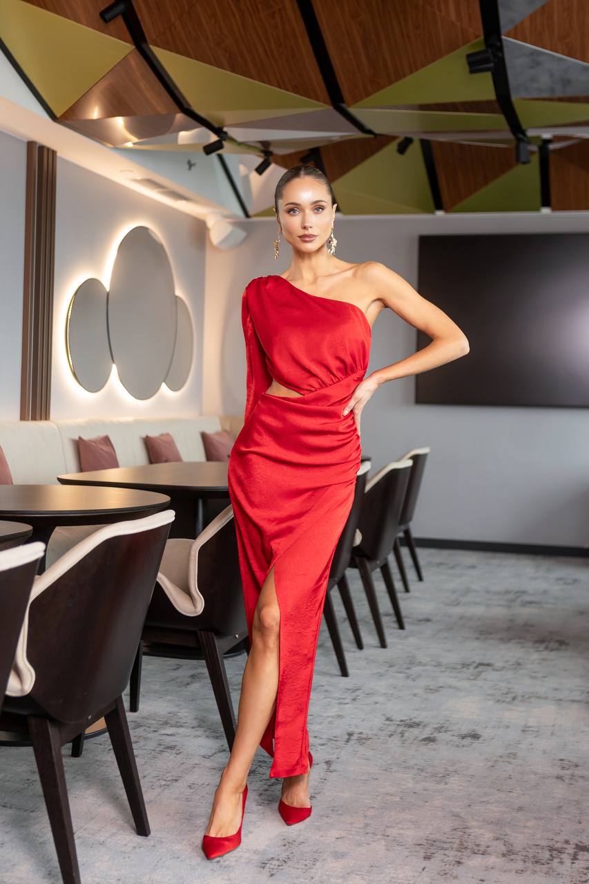 Woman in a red dress posing in a modern restaurant setting