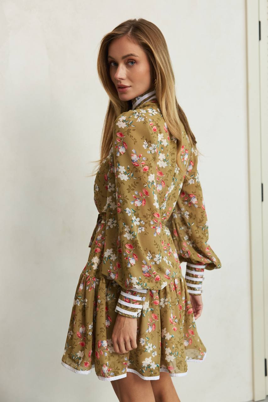 Woman wearing a floral dress with a plain background