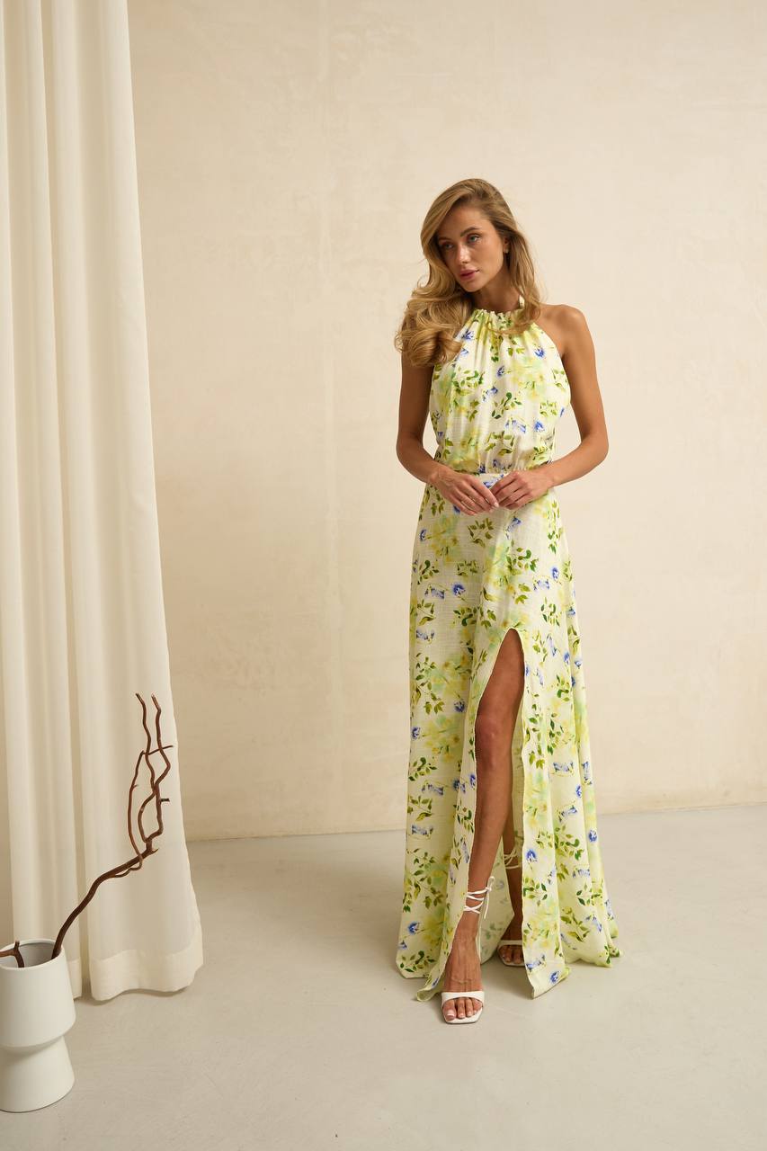 Woman wearing a floral dress with a slit in a minimalistic setting