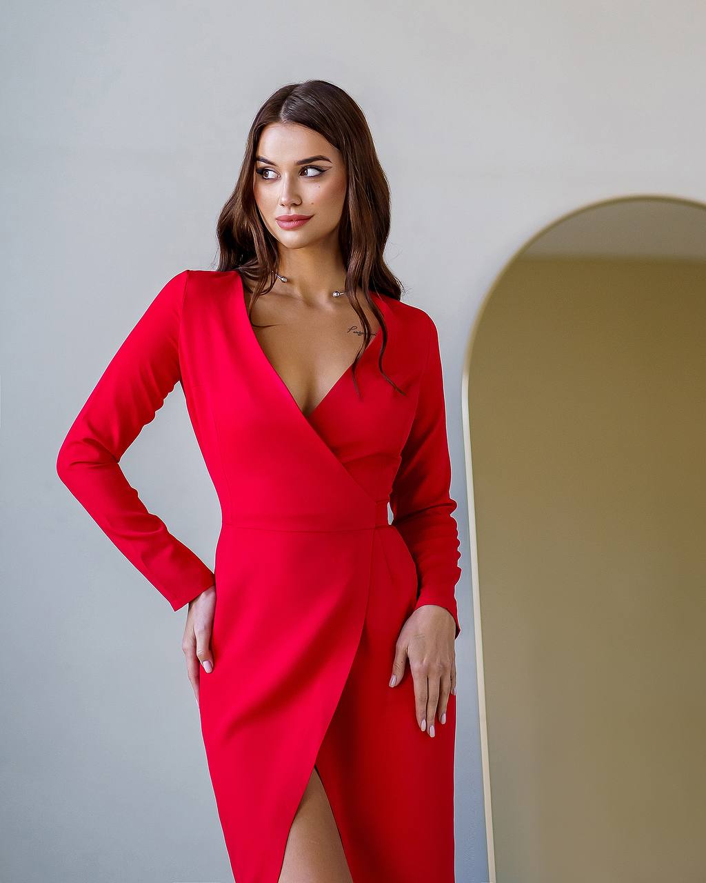 Woman wearing a red dress with a plain background