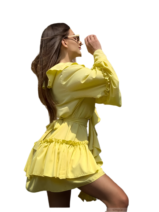 Woman wearing a yellow dress with ruffled details on a white background