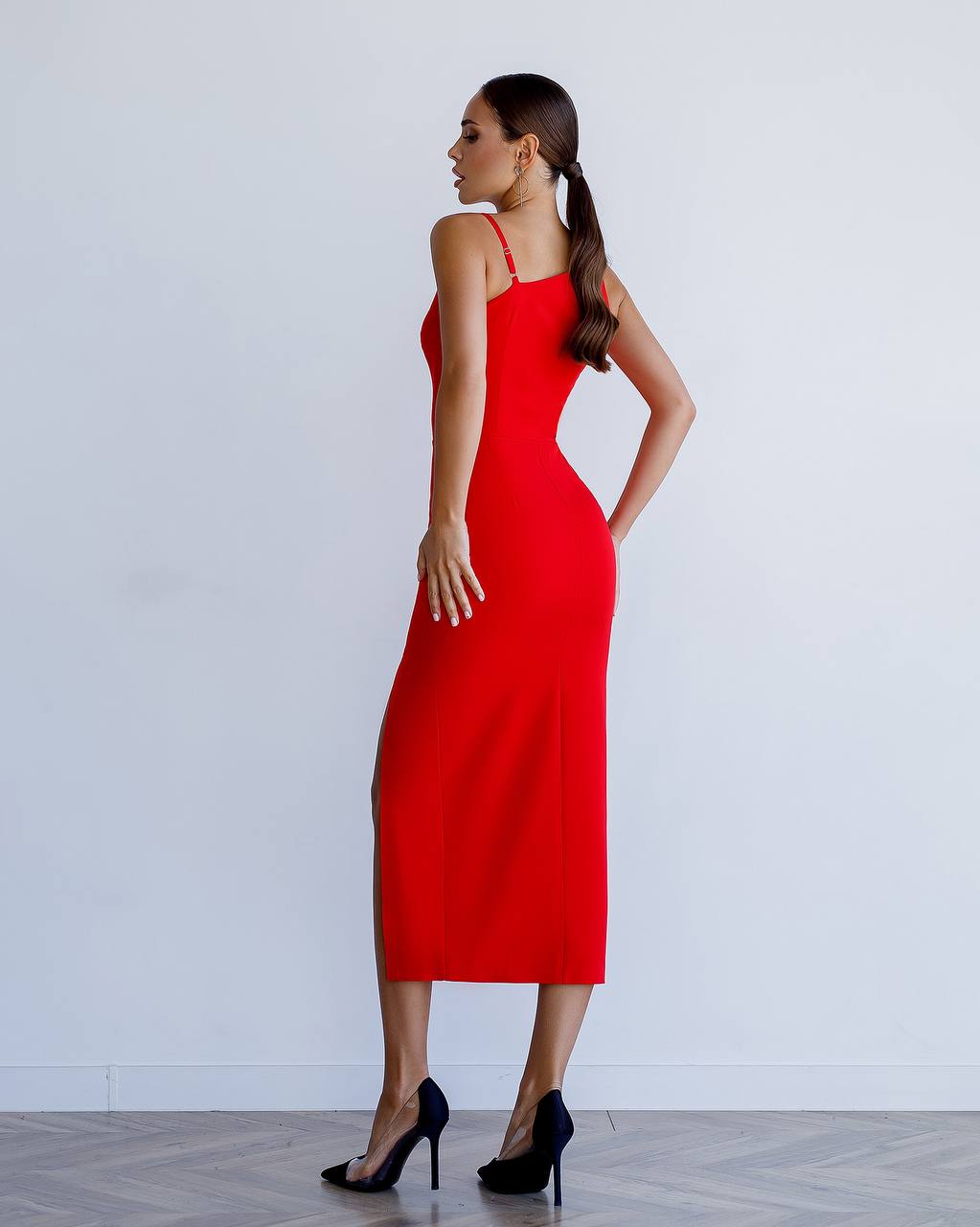 Woman wearing a red dress against a white background