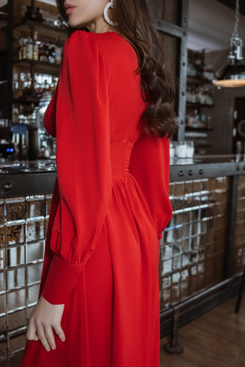 Person wearing a red dress in a bar setting