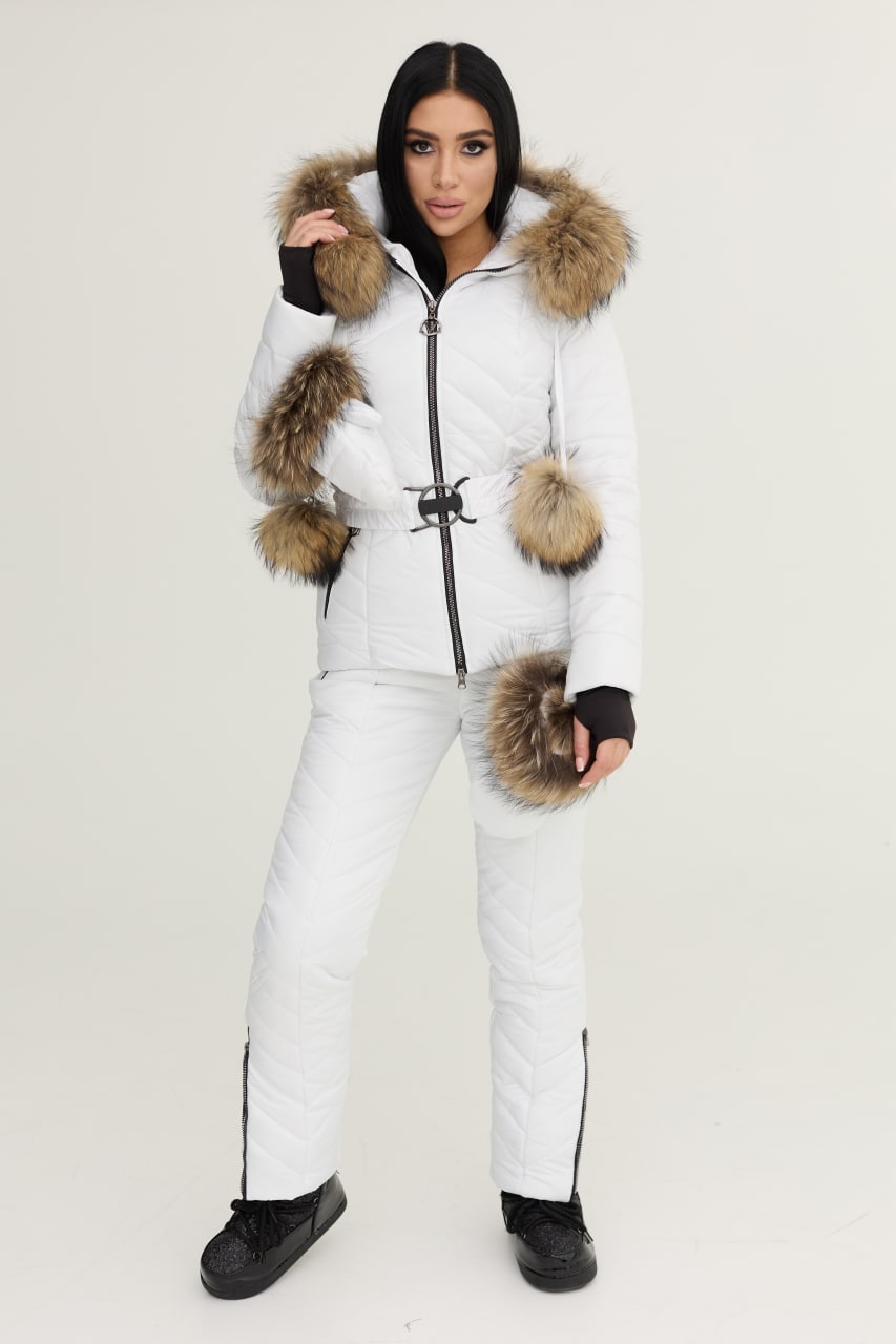 Person wearing a white winter outfit with fur-lined hood and cuffs on a plain background