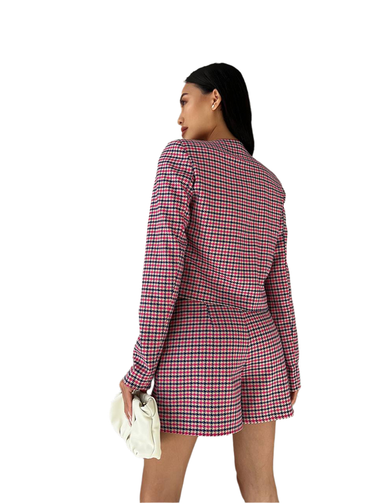 Woman wearing a red and black checkered blazer dress on a white background