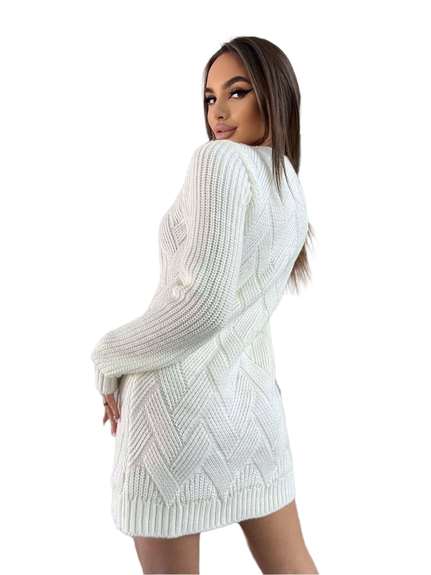 Woman wearing a white knitted dress with a plain background