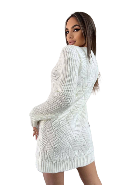 Woman wearing a white knitted dress with a plain background