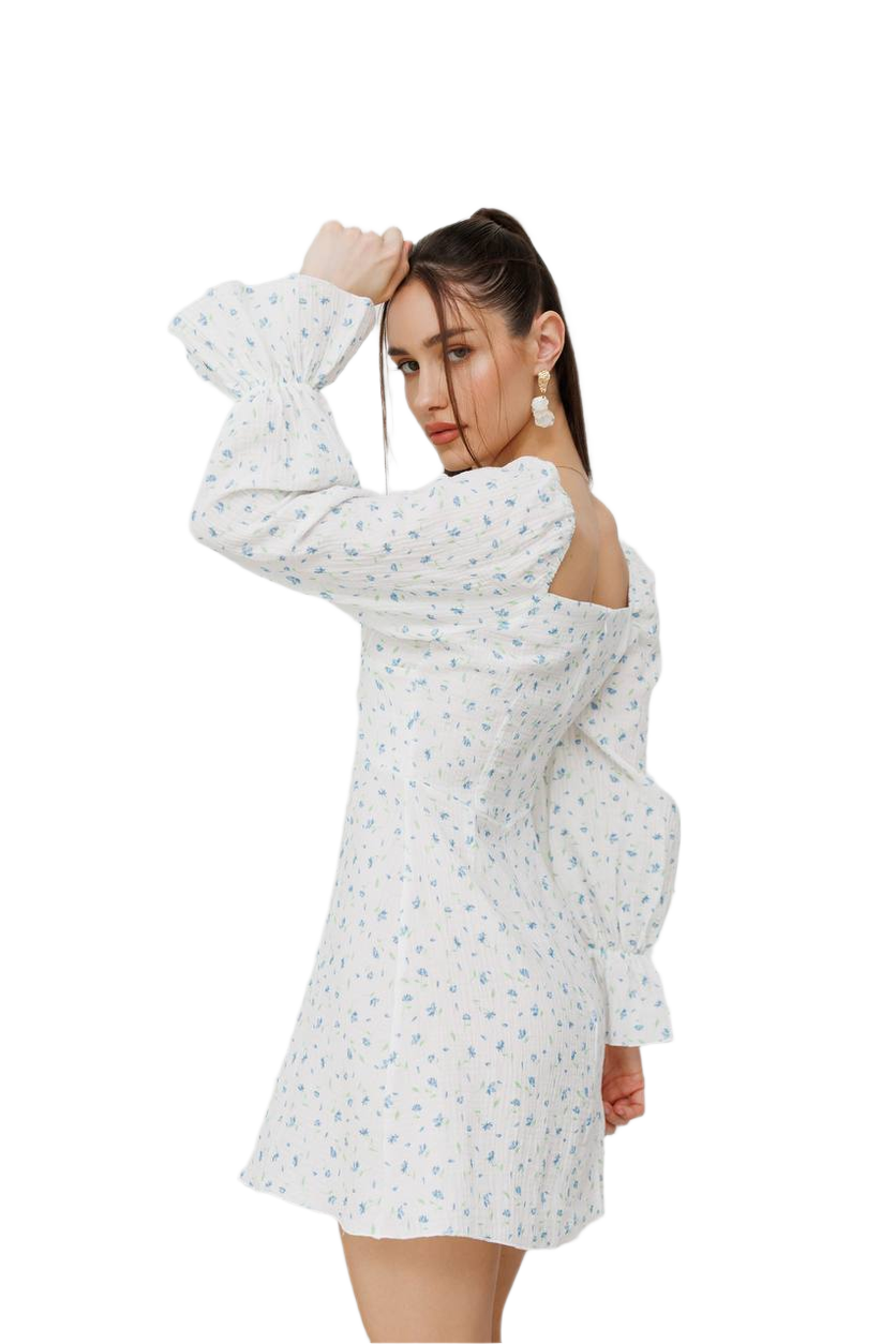 Woman wearing a white floral dress on a white background