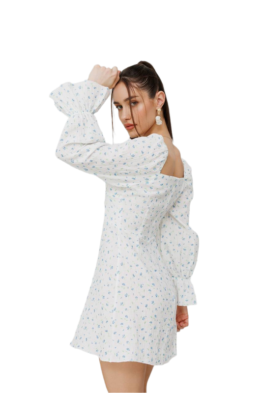 Woman wearing a white floral dress on a white background