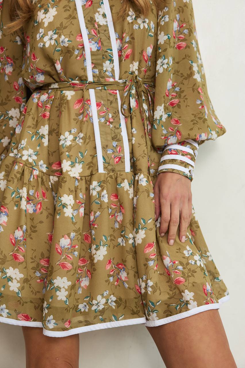 Floral dress with a white trim on a plain background