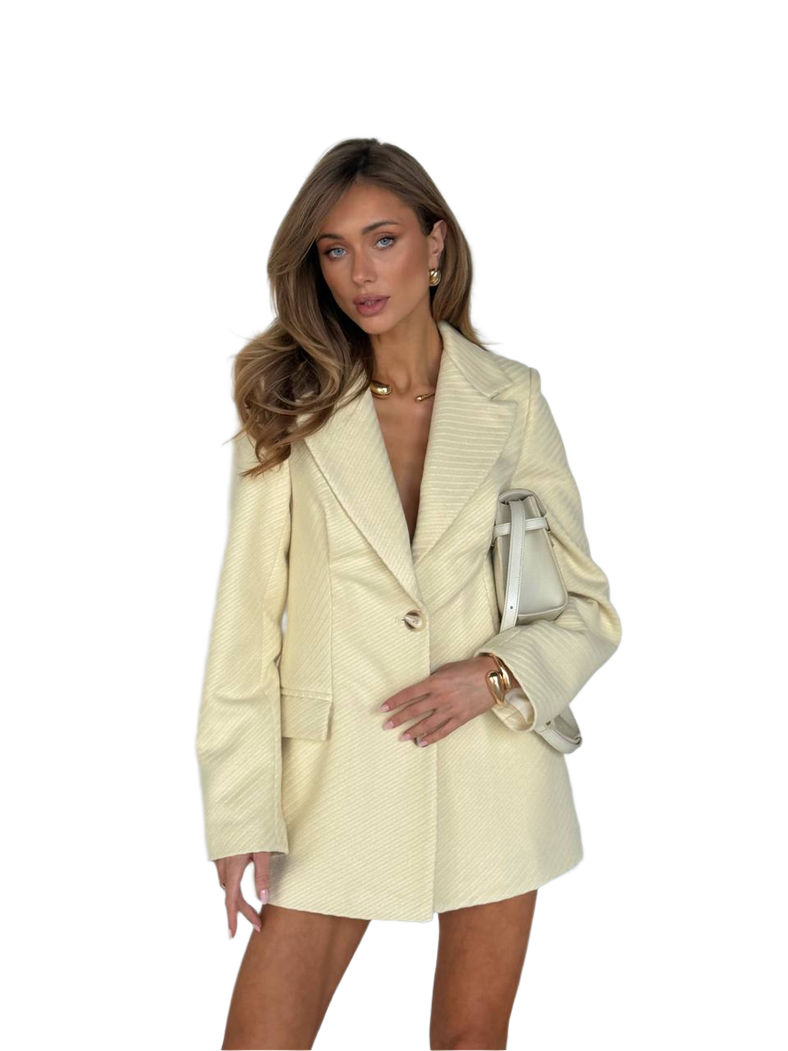 Woman wearing a beige suit with a white background