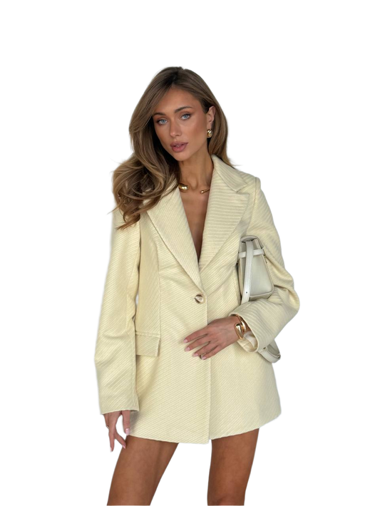 Woman wearing a beige suit with a white background