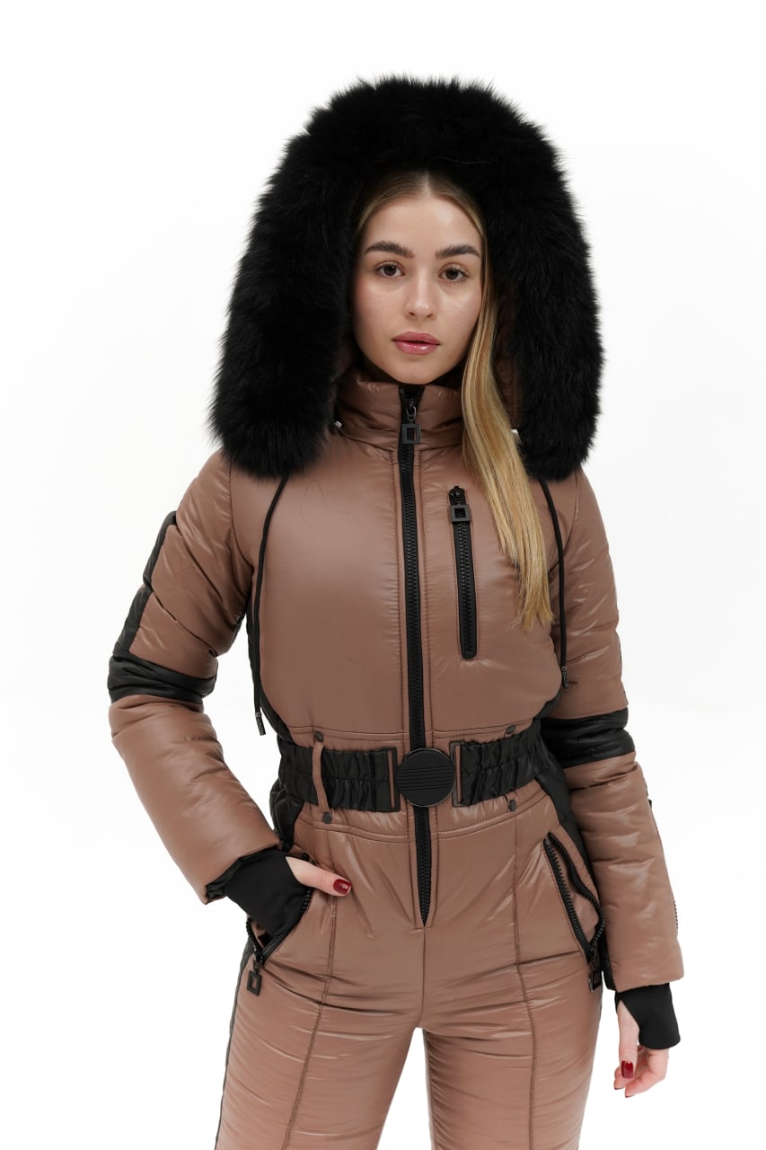 Person wearing a brown snowsuit with a black fur hood on a white background