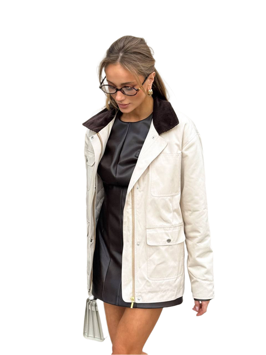 Woman wearing a white jacket with a black collar on a white background