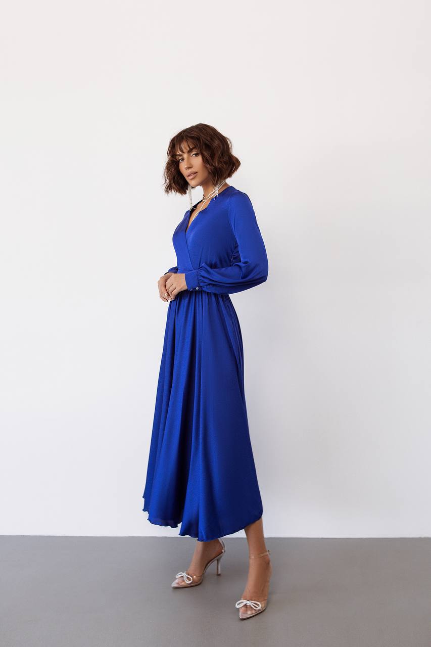 Woman wearing a blue dress against a white background