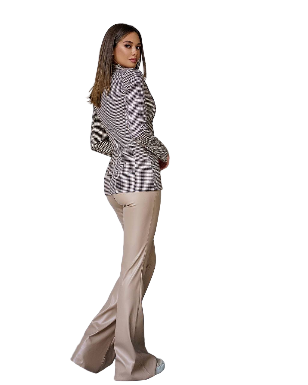 Woman wearing a checkered blazer and beige pants on a white background