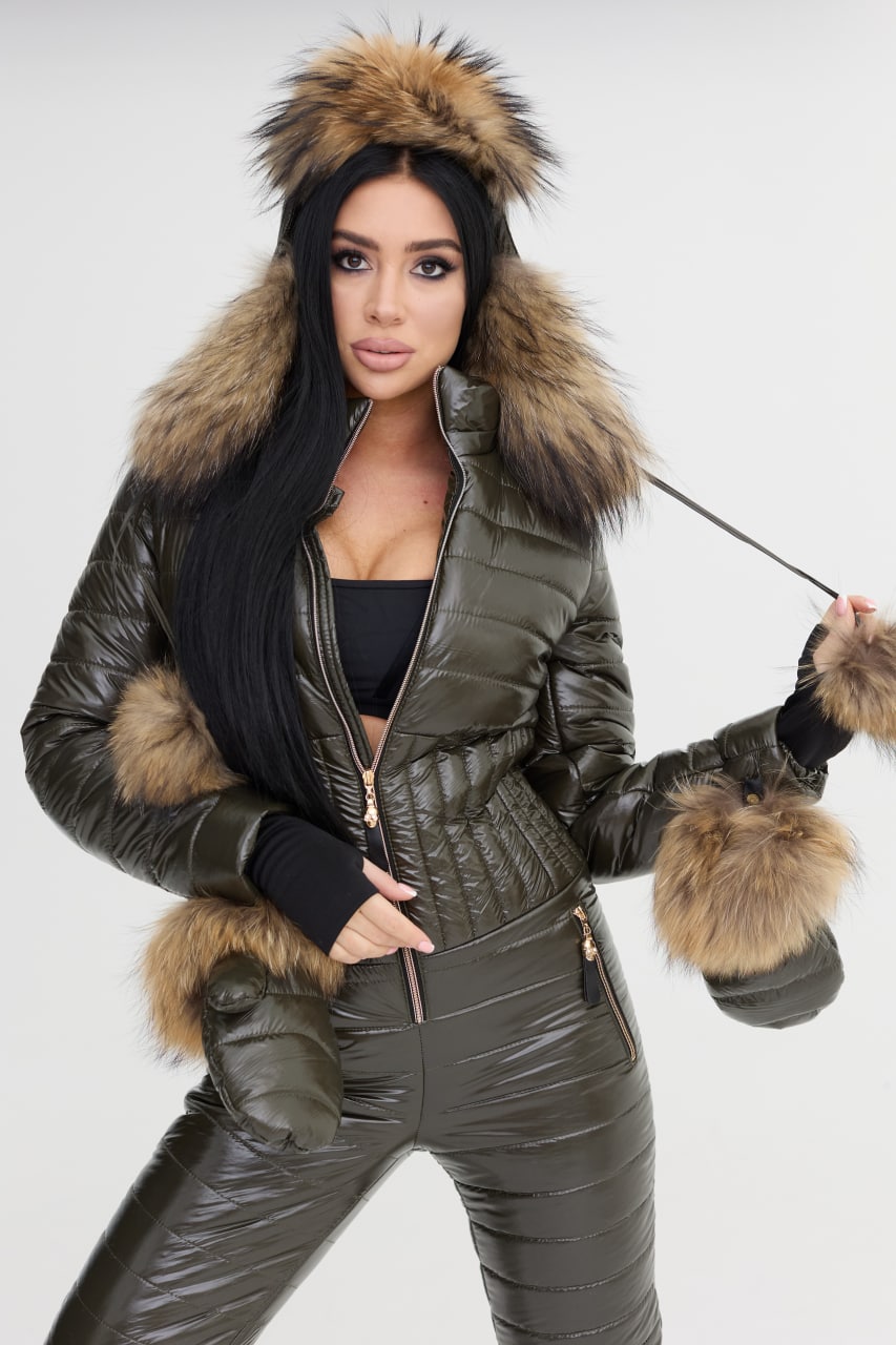 Person wearing a green puffer jacket with fur trim on a white background