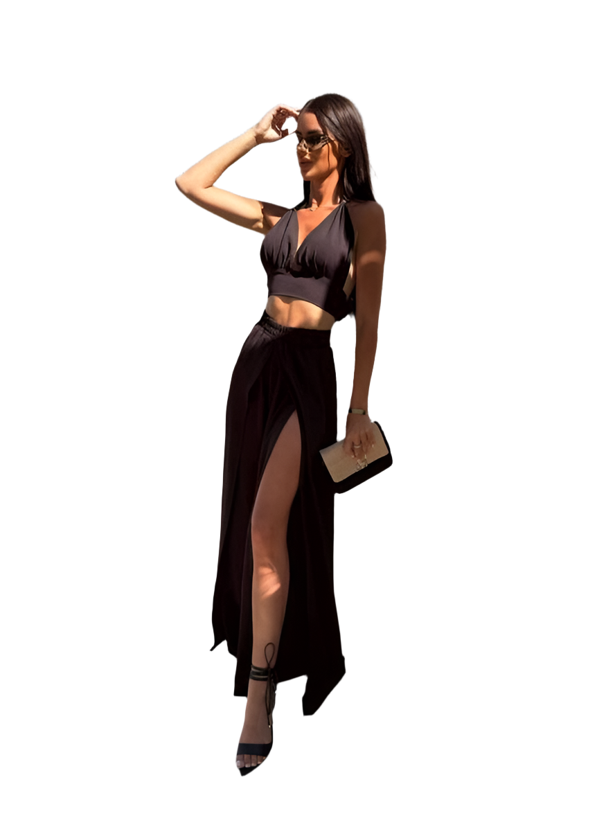 Woman wearing a black outfit with a high slit on a white background