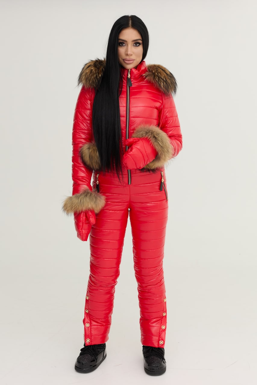 Person wearing a red puffer suit with fur trim on a white background