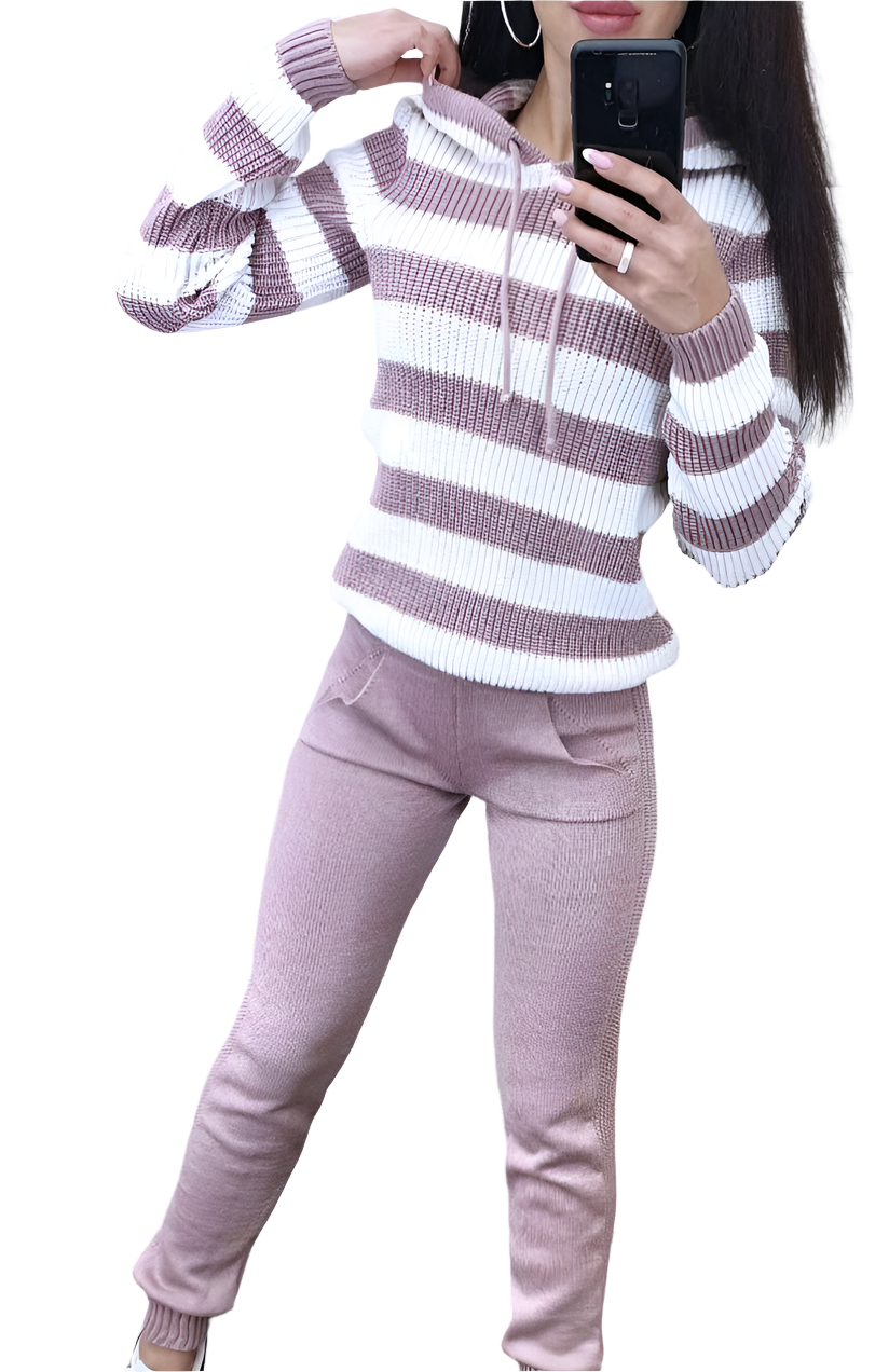 Person wearing a striped sweater and pants, taking a mirror selfie.