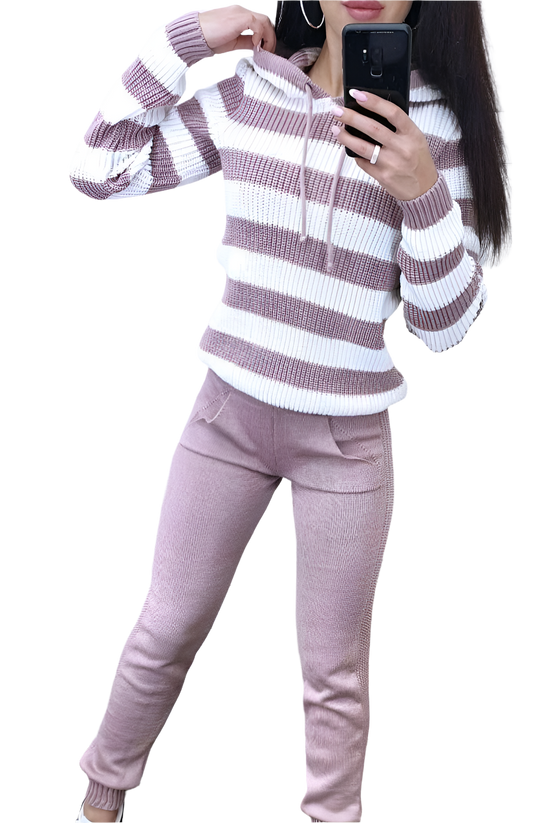 Person wearing a striped sweater and pants, taking a mirror selfie.