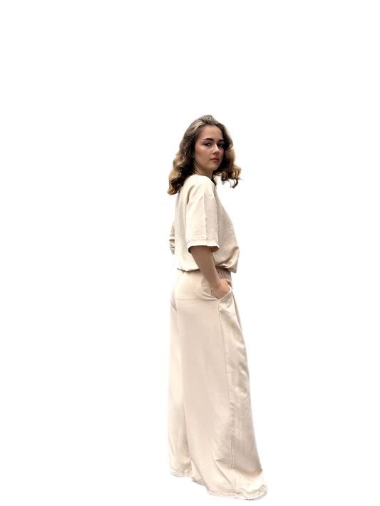 Woman wearing a beige long dress on a white background