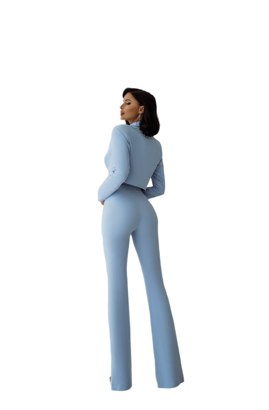 Woman wearing a light blue jumpsuit on a white background