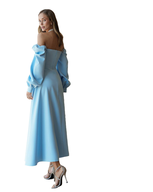 Woman wearing a light blue dress with ruffled sleeves on a white background