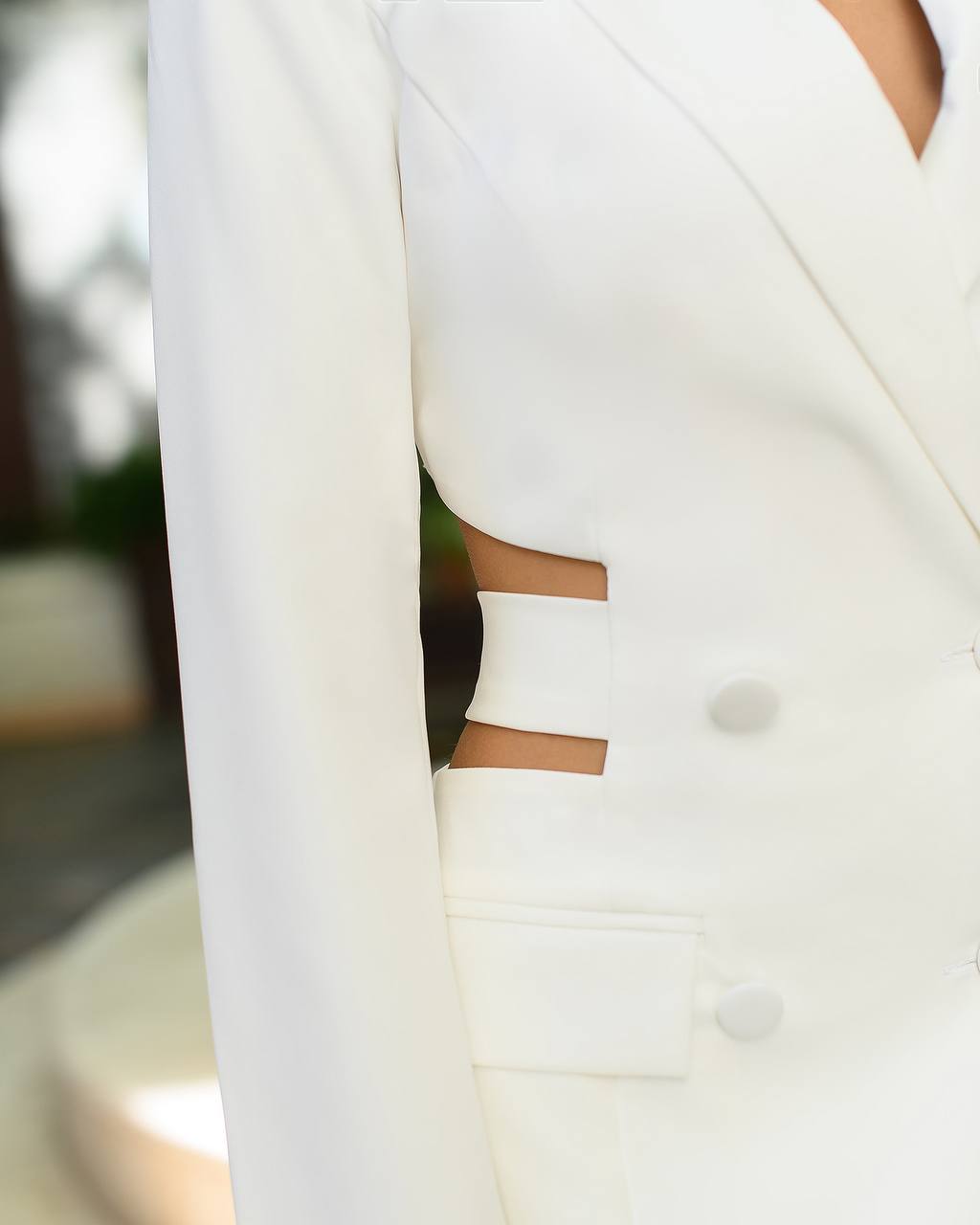 Close-up of a white blazer with a blurred background