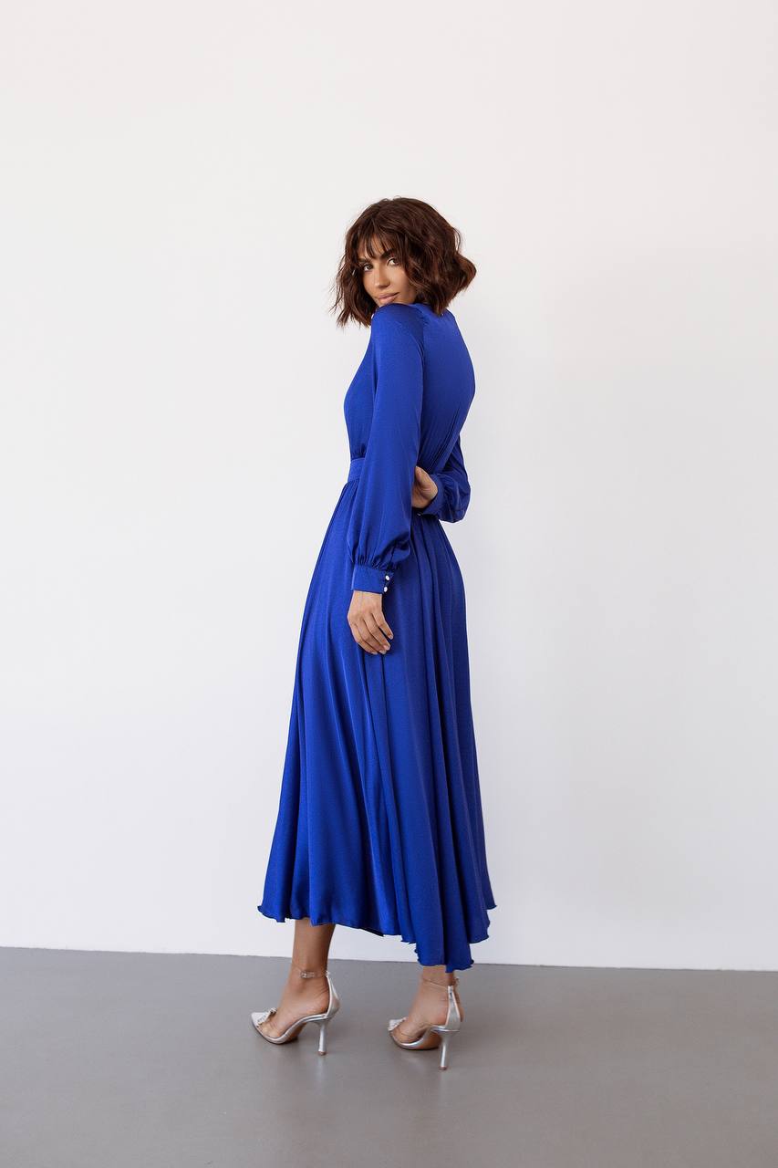 Woman wearing a blue dress against a white background