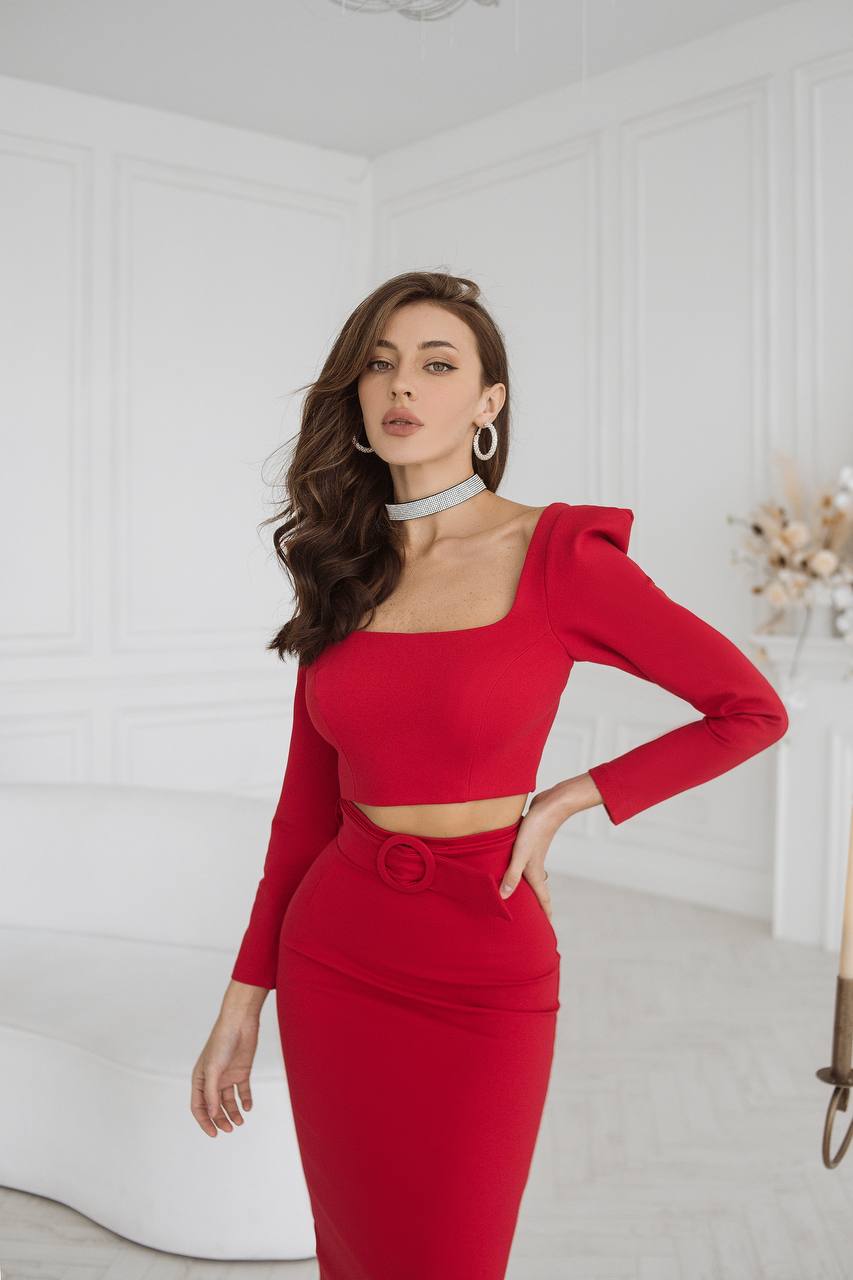 Woman wearing a red dress with a white background