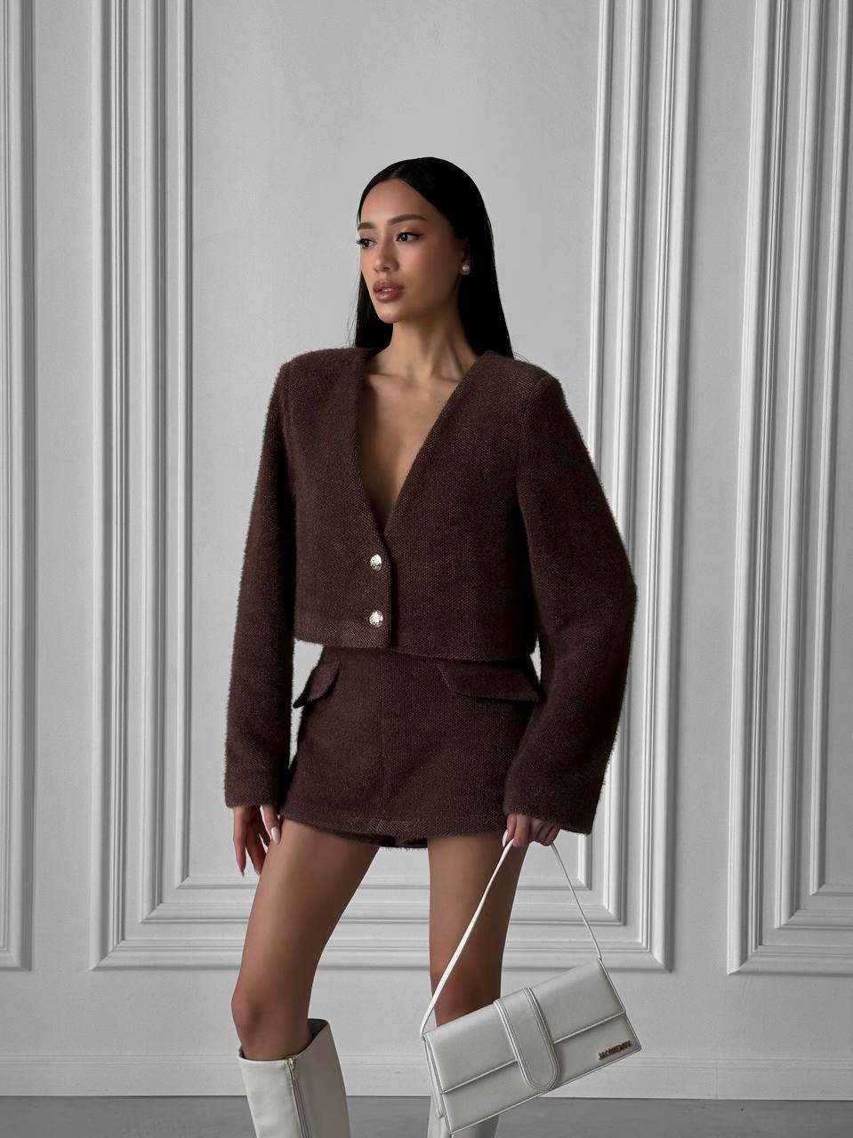 Woman wearing a brown outfit with a white background