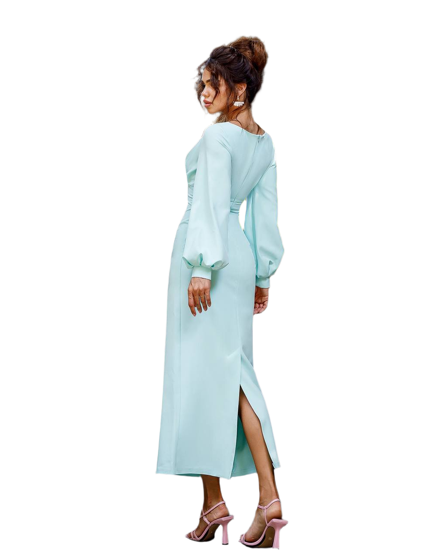 Woman wearing a light blue dress with long sleeves and a slit on a white background