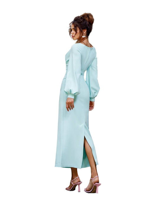 Woman wearing a light blue dress with long sleeves and a slit on a white background
