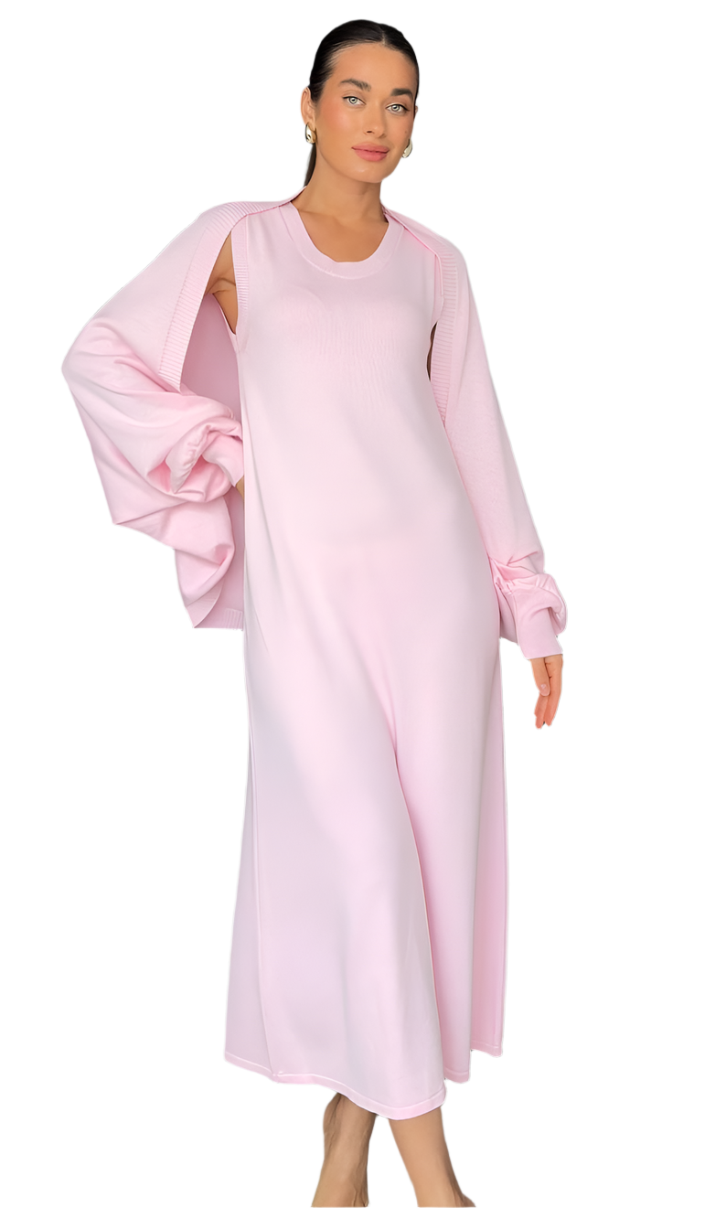 Woman wearing a light pink dress with a soft texture on a white background