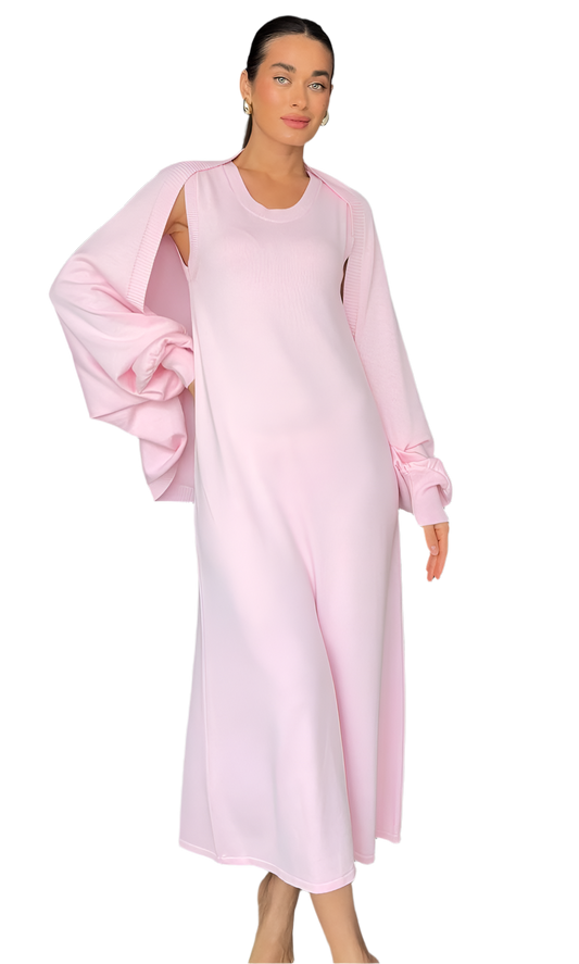 Woman wearing a light pink dress with a soft texture on a white background