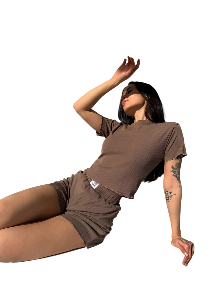 Person wearing a brown outfit on a white background