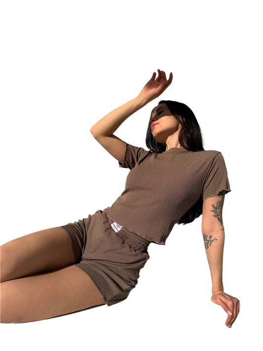 Person wearing a brown outfit on a white background