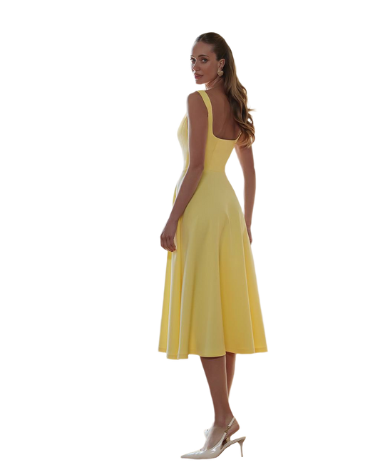 Woman wearing a yellow dress on a white background