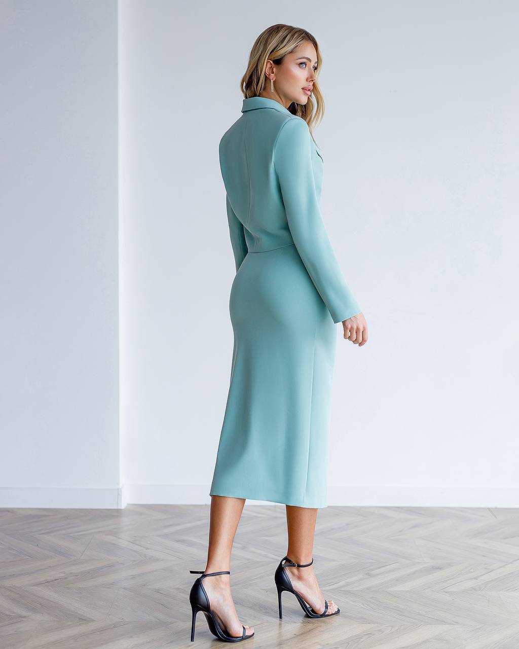 Woman wearing a light blue dress against a white background