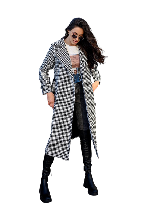 Woman wearing a long houndstooth coat on a white background