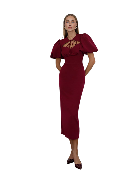 Woman wearing a burgundy dress with puff sleeves on a white background