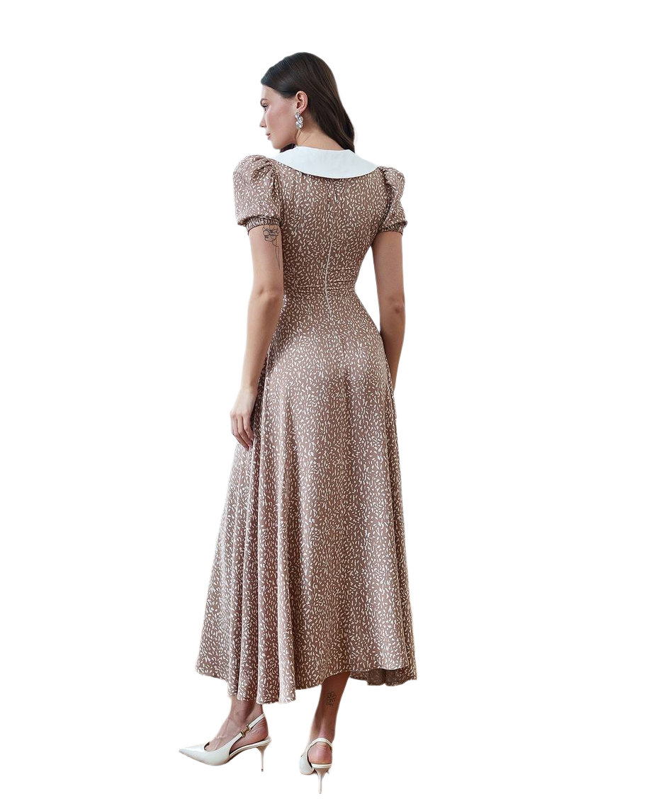 Woman wearing a patterned dress on a white background