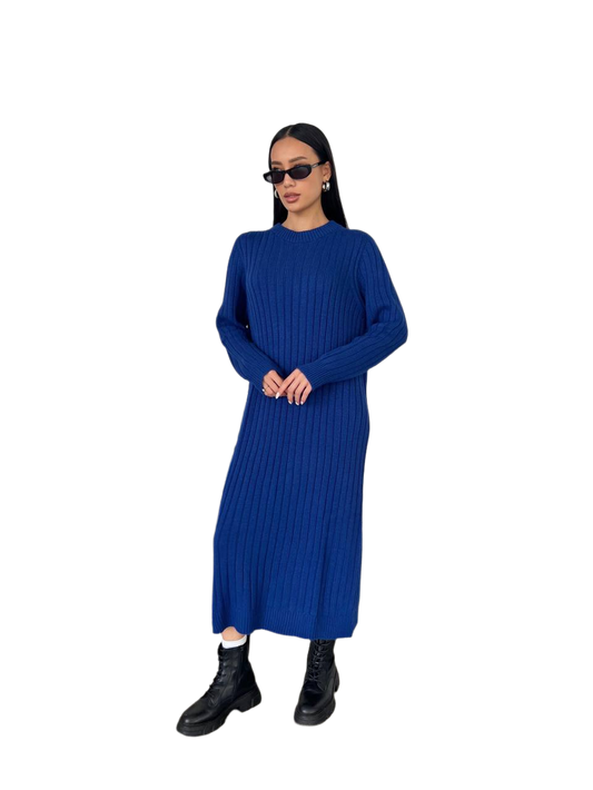 Woman wearing a blue ribbed dress on a white background