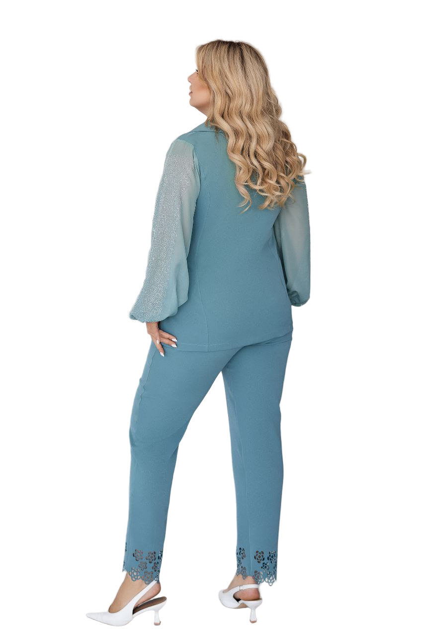 Woman wearing a teal outfit with a matching top and pants on a white background