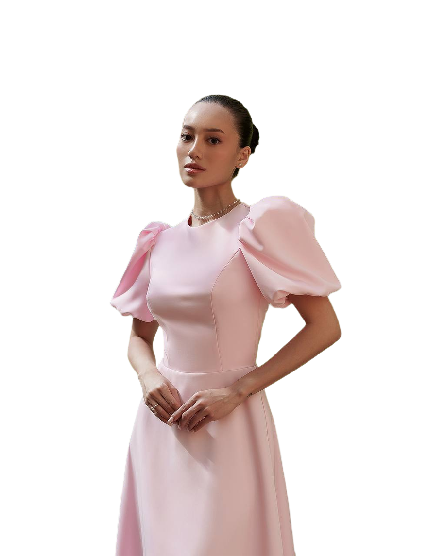 Woman wearing a pink dress with puffed sleeves on a white background