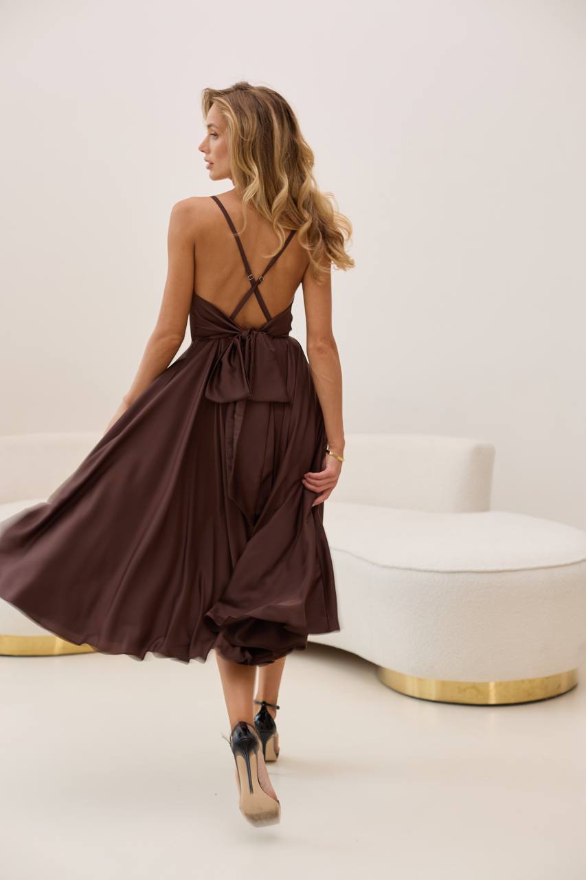 Woman wearing a brown dress with a white background