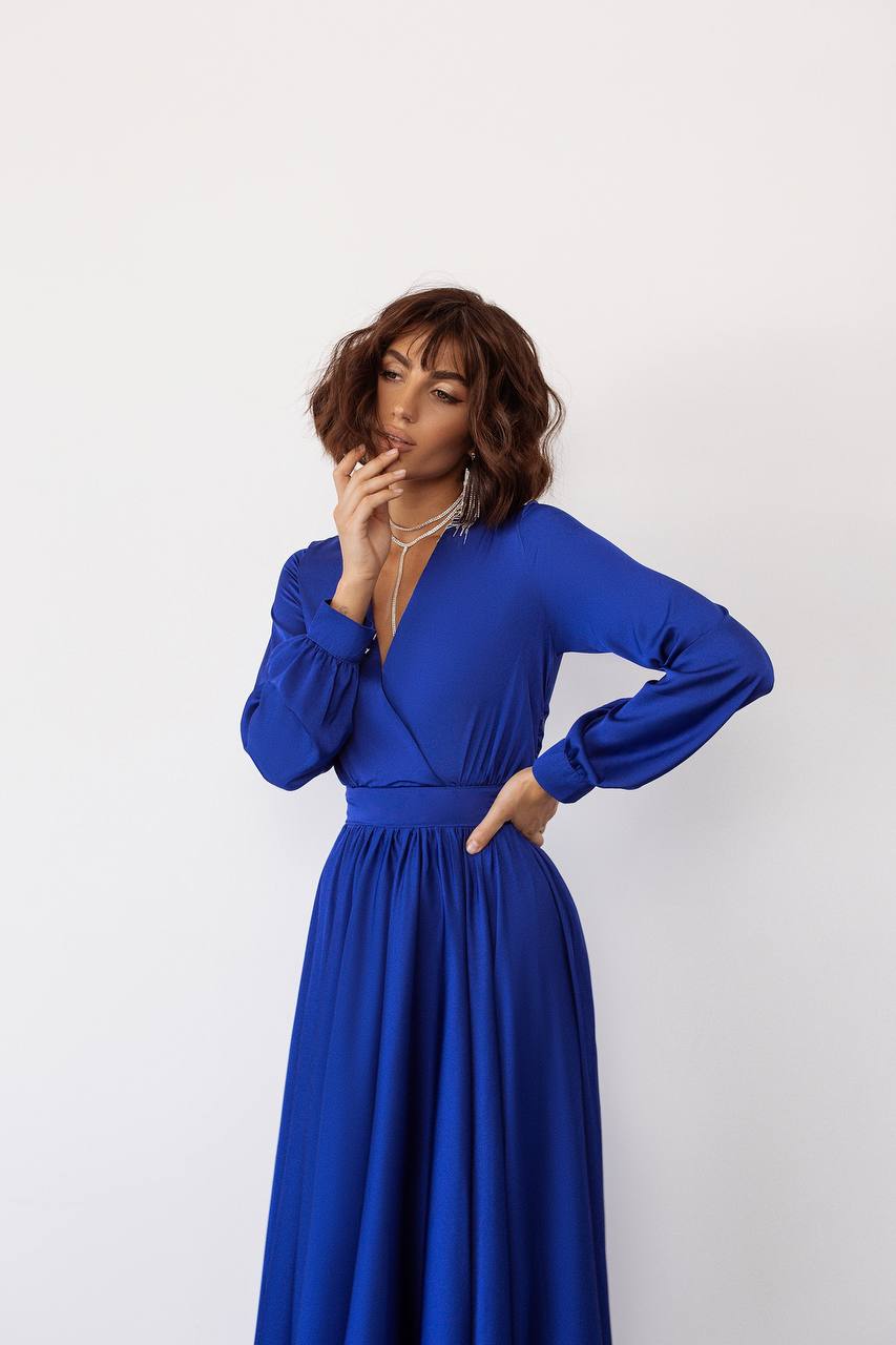 Woman wearing a blue dress against a white background