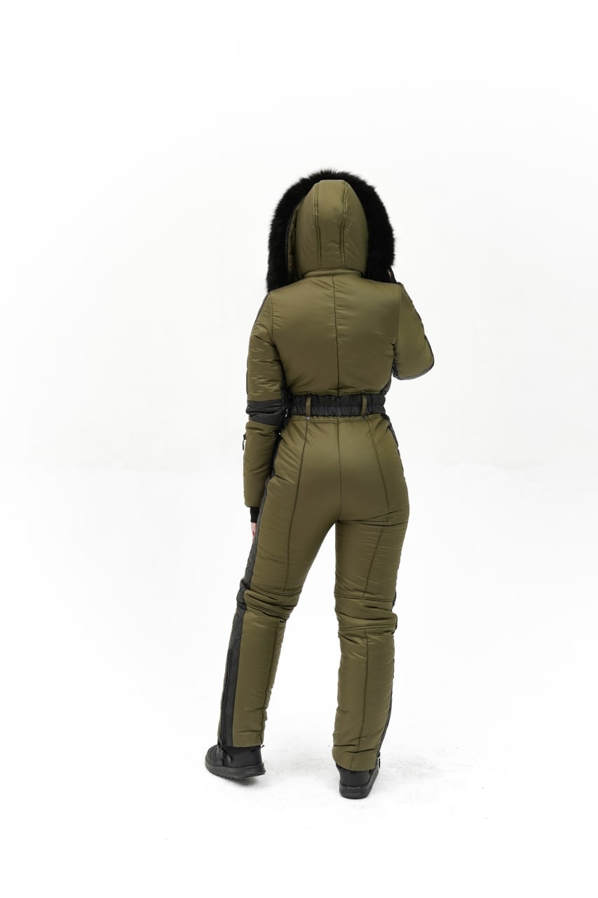 Person wearing a green jumpsuit with black accents on a white background