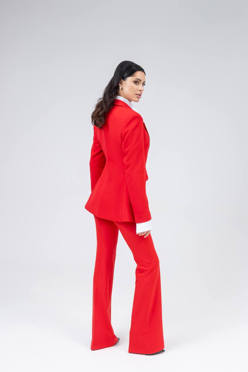 Woman wearing a red suit on a white background